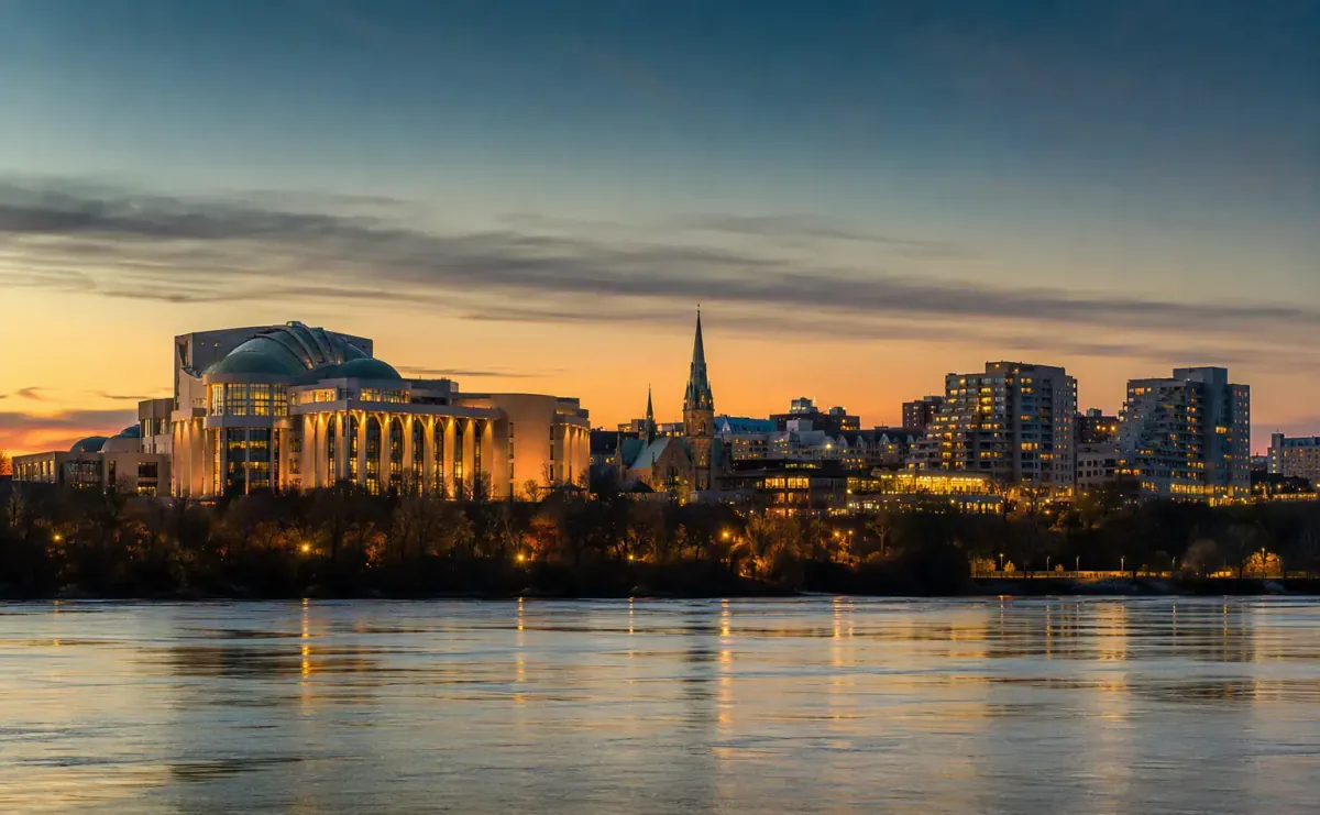 Gatineau skyline across the Ottawa River at dusk with warm reflections