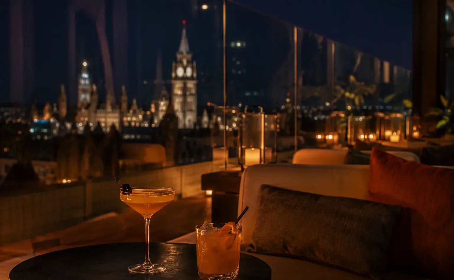 Sophisticated rooftop hotel lounge in Ottawa at night with cocktails and city lights